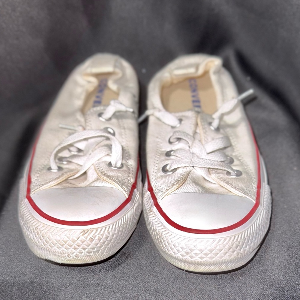 Converse Shoreline slip-on sneakers in white canvas with a red stripe detail.